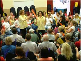 High energy activity all play brightly coloured Boomwhacker percussion tubes.